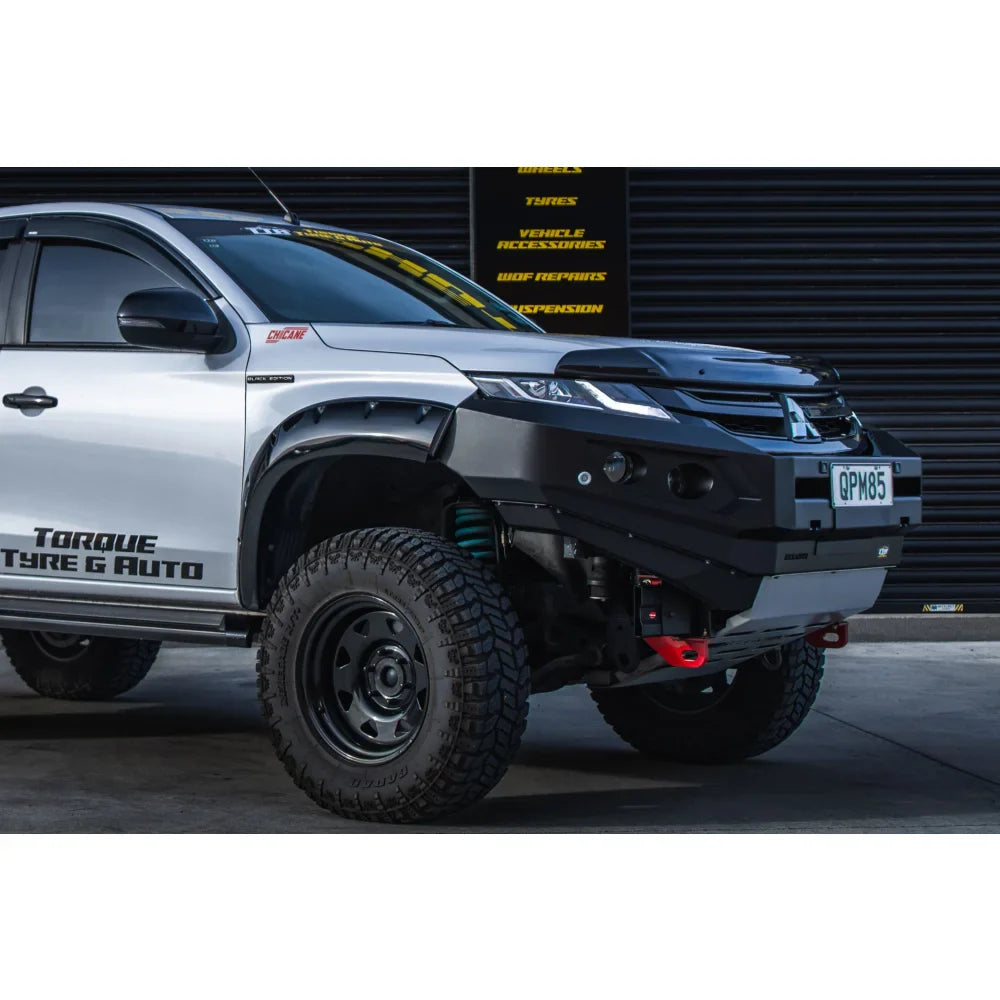 Silver pickup truck with black bull bar and driving lights on Mitsubishi MR Triton