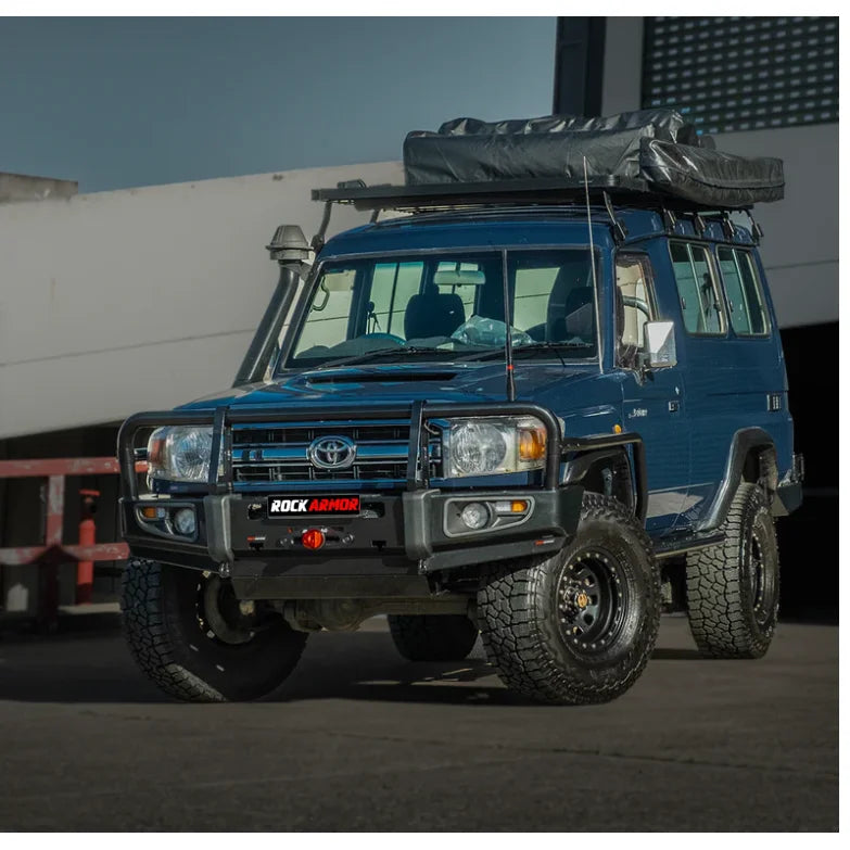 Blue off-road vehicle with roof tent and steel checker plate side steps for Toyota Landcruiser